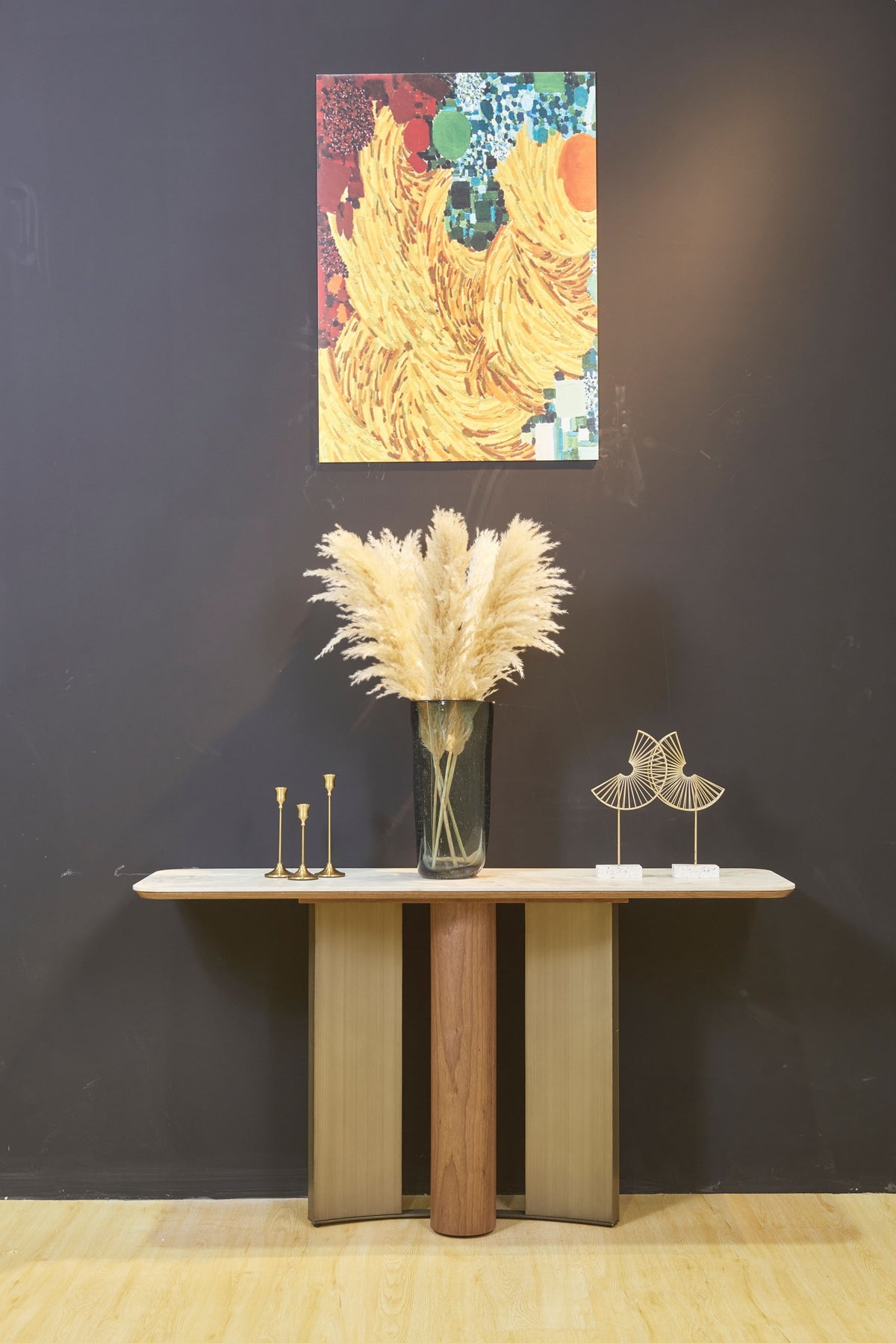 ELISE walnut veneer and brushed bronze console table styled against a dark wall – front view