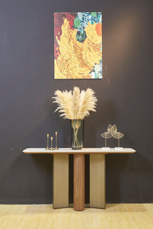 ELISE walnut veneer and brushed bronze console table styled against a dark wall – front view