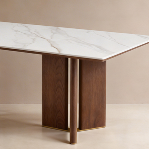 Close-up of KIRA white veined sintered stone tabletop, walnut pedestal and slim matt gold trim