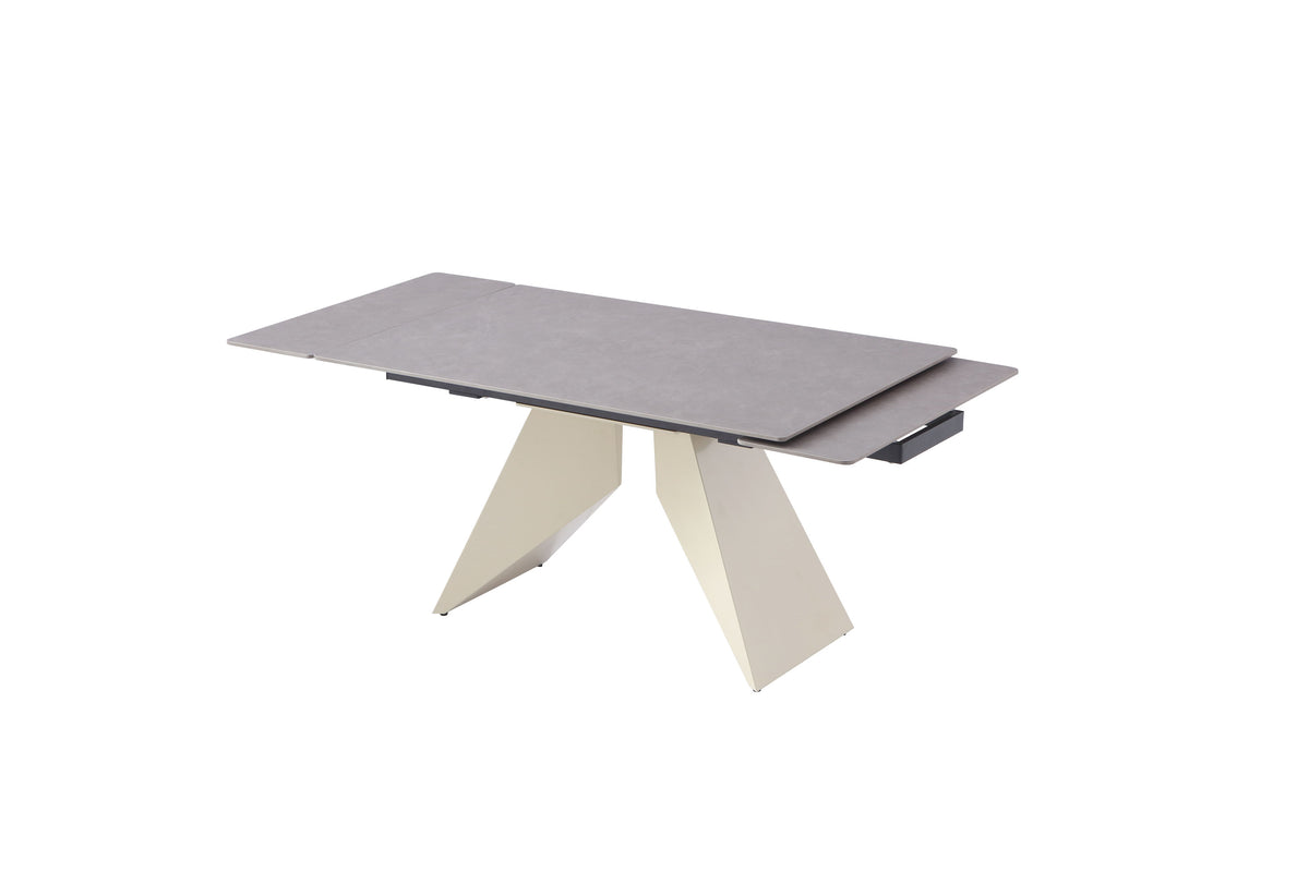 Modern beige extension dining table showing rotating grey sintered stone extension leaf partially opened